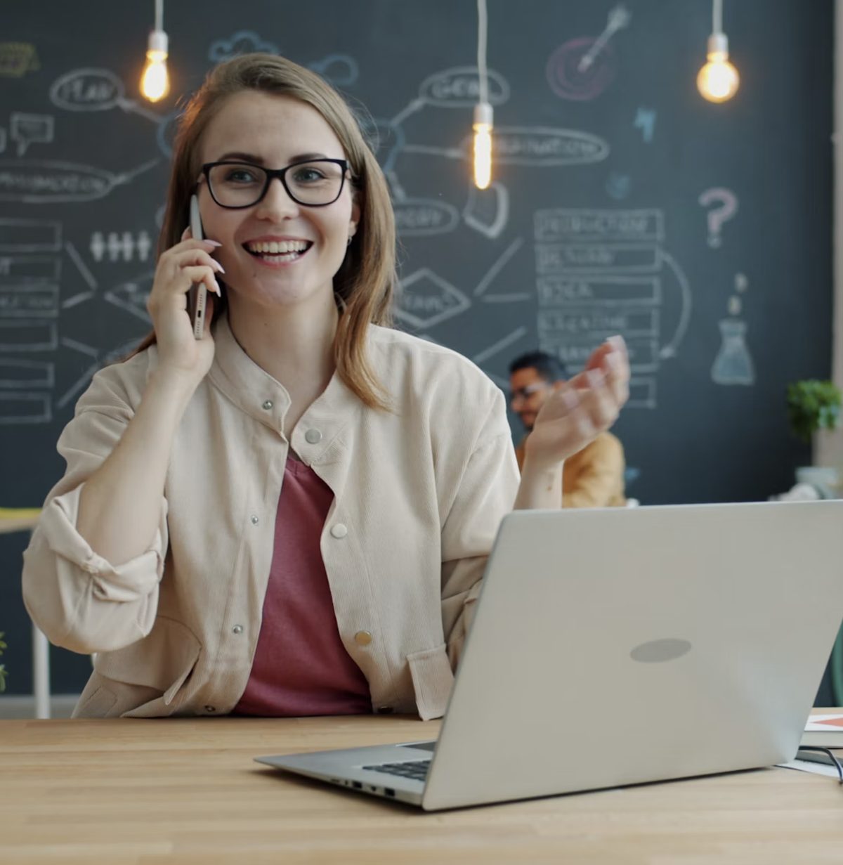 Business owner on the phone working at a laptop